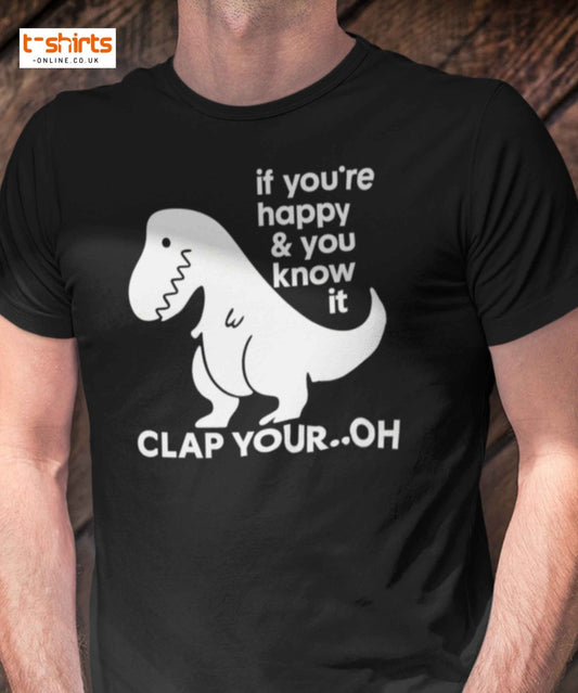 Black t-shirt with a dinosaur graphic and text on a wooden surface