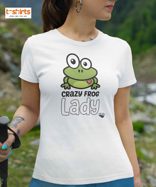 Person wearing a white t-shirt with a green frog graphic and text in an outdoor setting