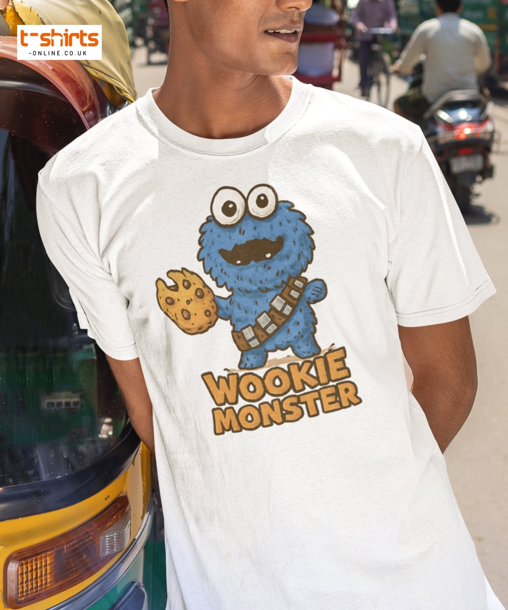Person wearing a white t-shirt with a 'Wookie Monster' design in an urban setting.