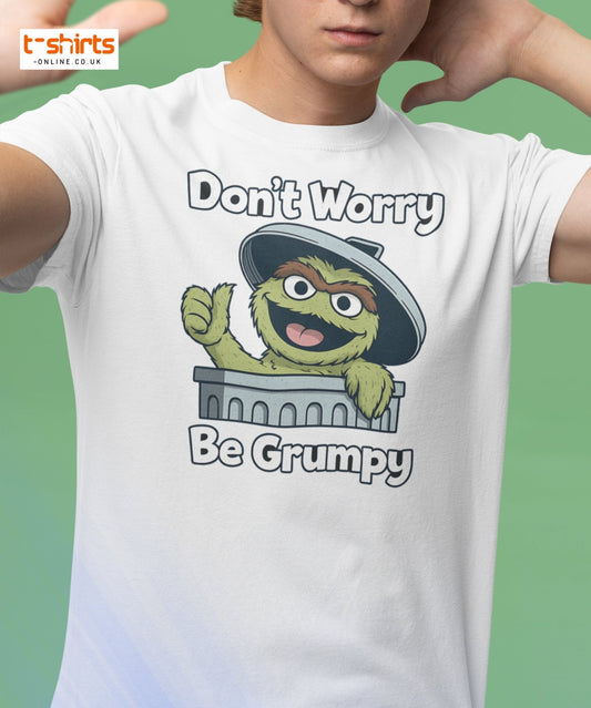 Person wearing a white t-shirt with a cartoon character and text 'Don't Worry Be Grumpy' on a green background.