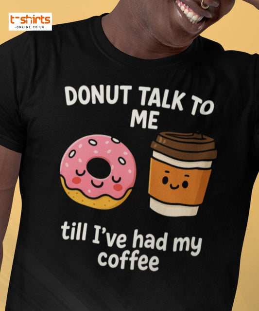 Black t-shirt with a donut and coffee cup graphic and text on a beige background
