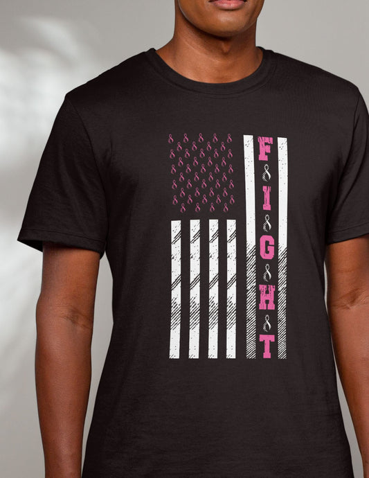 Man wearing a black T-shirt with an American flag and pink ribbons spelling out “FIGHT” in support of cancer awareness.