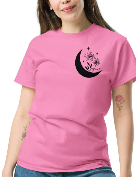 Pink t-shirt featuring a black crescent moon with flowers and stars printed on the chest area for a dreamy, celestial look.