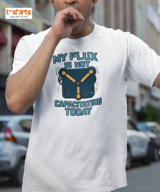 Person wearing a white t-shirt with a humorous graphic and text in an urban setting
