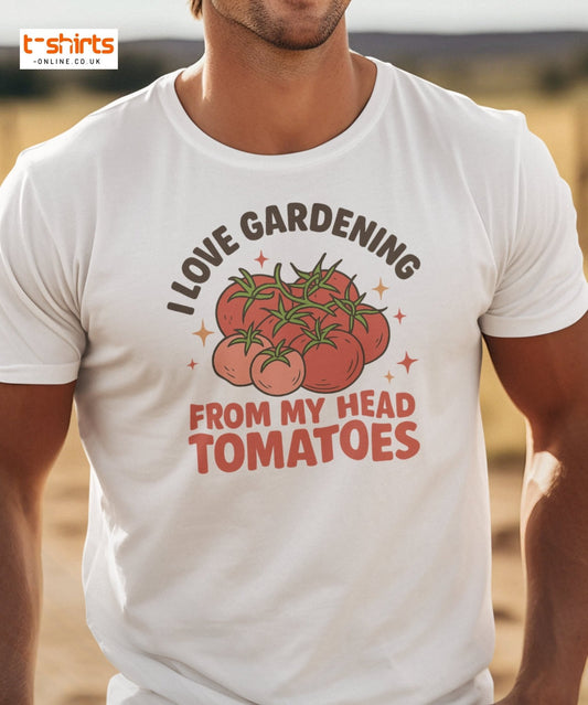 White t-shirt with tomato graphic and text worn by a person, set against a blurred outdoor background.