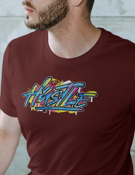 Man wearing a maroon t-shirt with graffiti-style “Hustle” text in vibrant colors, expressing motivation urban street style.
