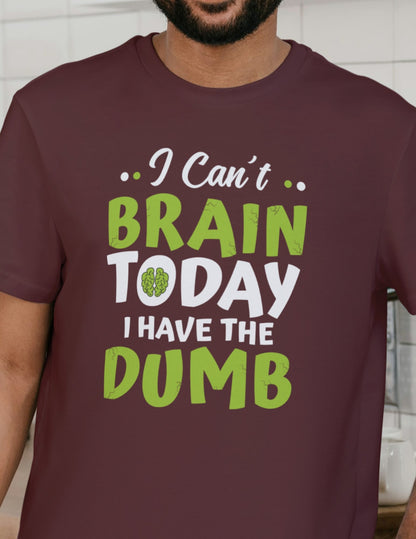 Man wearing a maroon t-shirt with the funny quote “I Can’t Brain Today, I Have the Dumb” in bold green and white letters.
