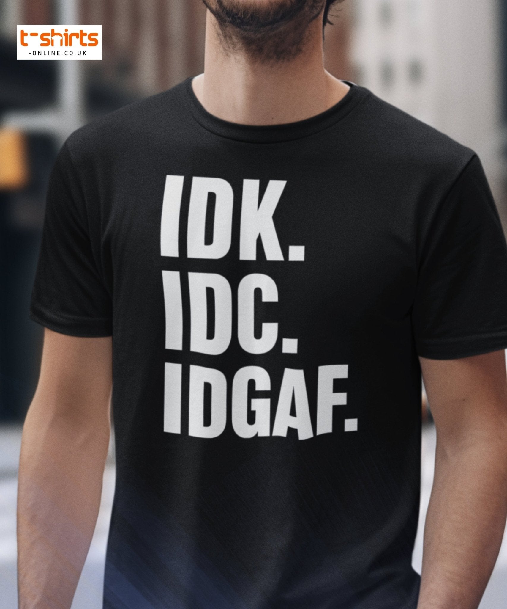 Black t-shirt with white text 'IDK. IDC. IDGAF.' worn by a person.
