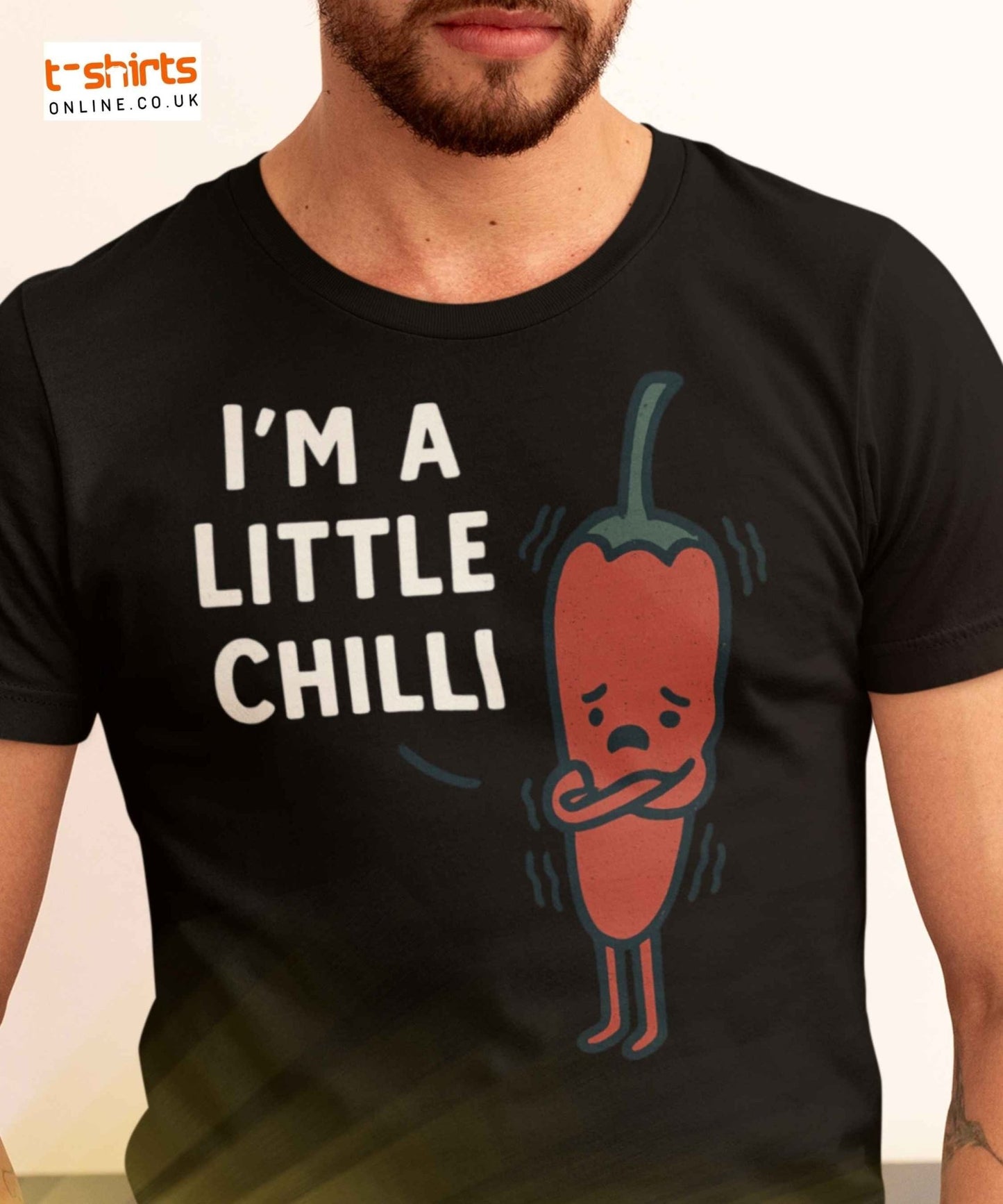 Cartoon red chilli pepper shivering with arms crossed beside the text "I’m a little chilli" in white font on transparent background.