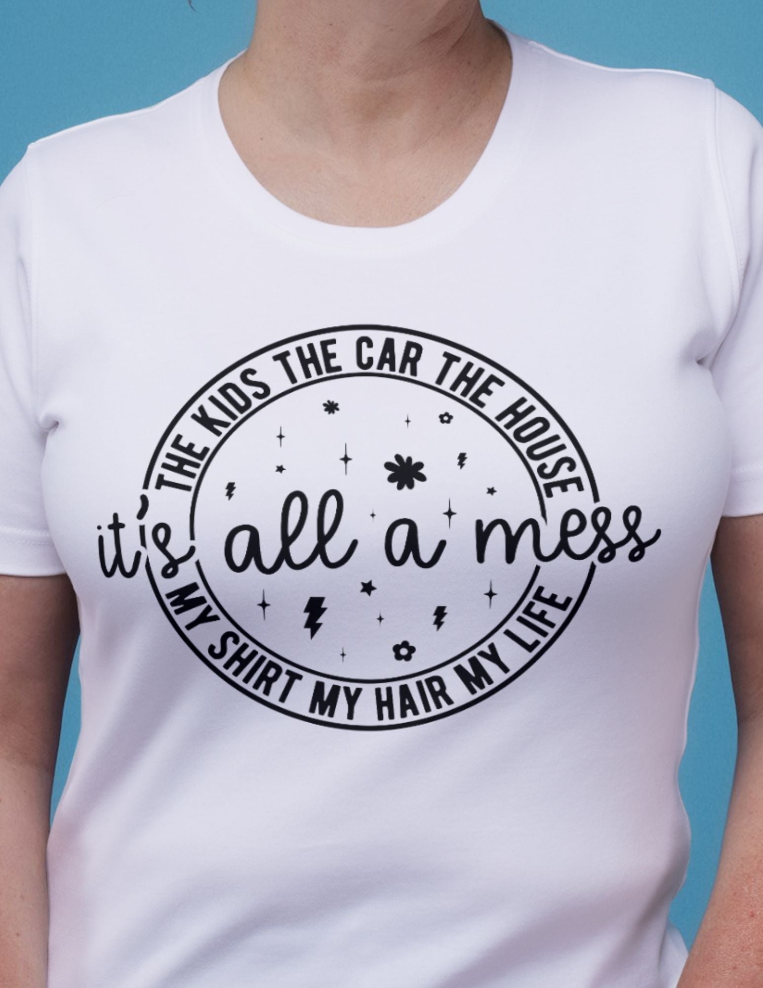 White t-shirt with playful black text: “It’s All a Mess – The Kids, The Car, The House, My Shirt, My Hair, My Life.”
