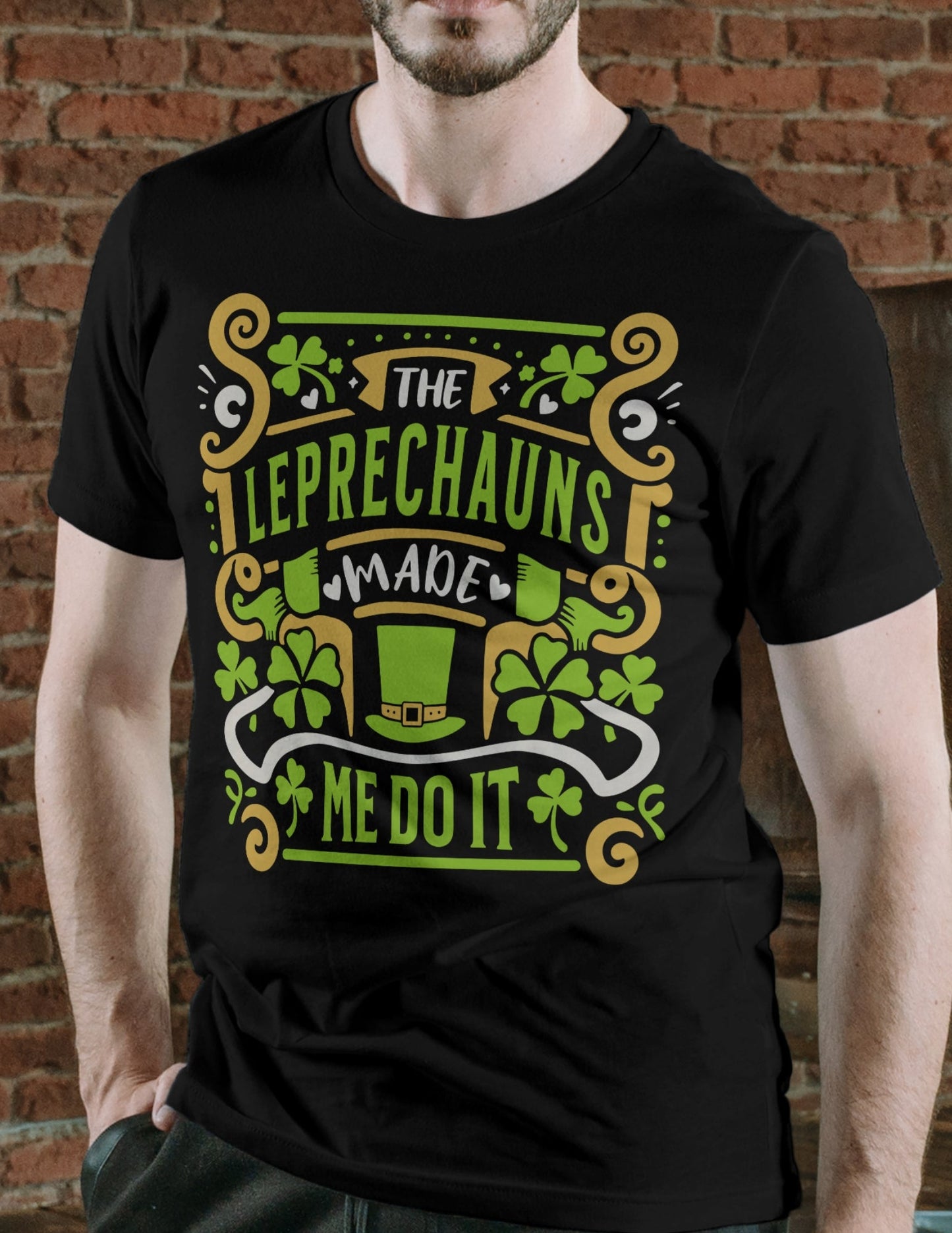 Man wearing a black t-shirt with bold green and gold “The Leprechauns Made Me Do It” text and shamrock graphics.