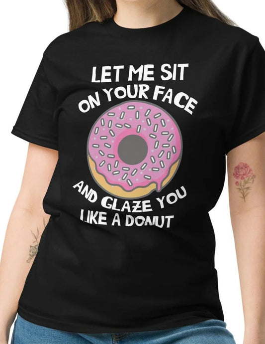 Black t-shirt with a pink frosted donut and the adult phrase “Let me sit on your face and glaze you like a donut.”