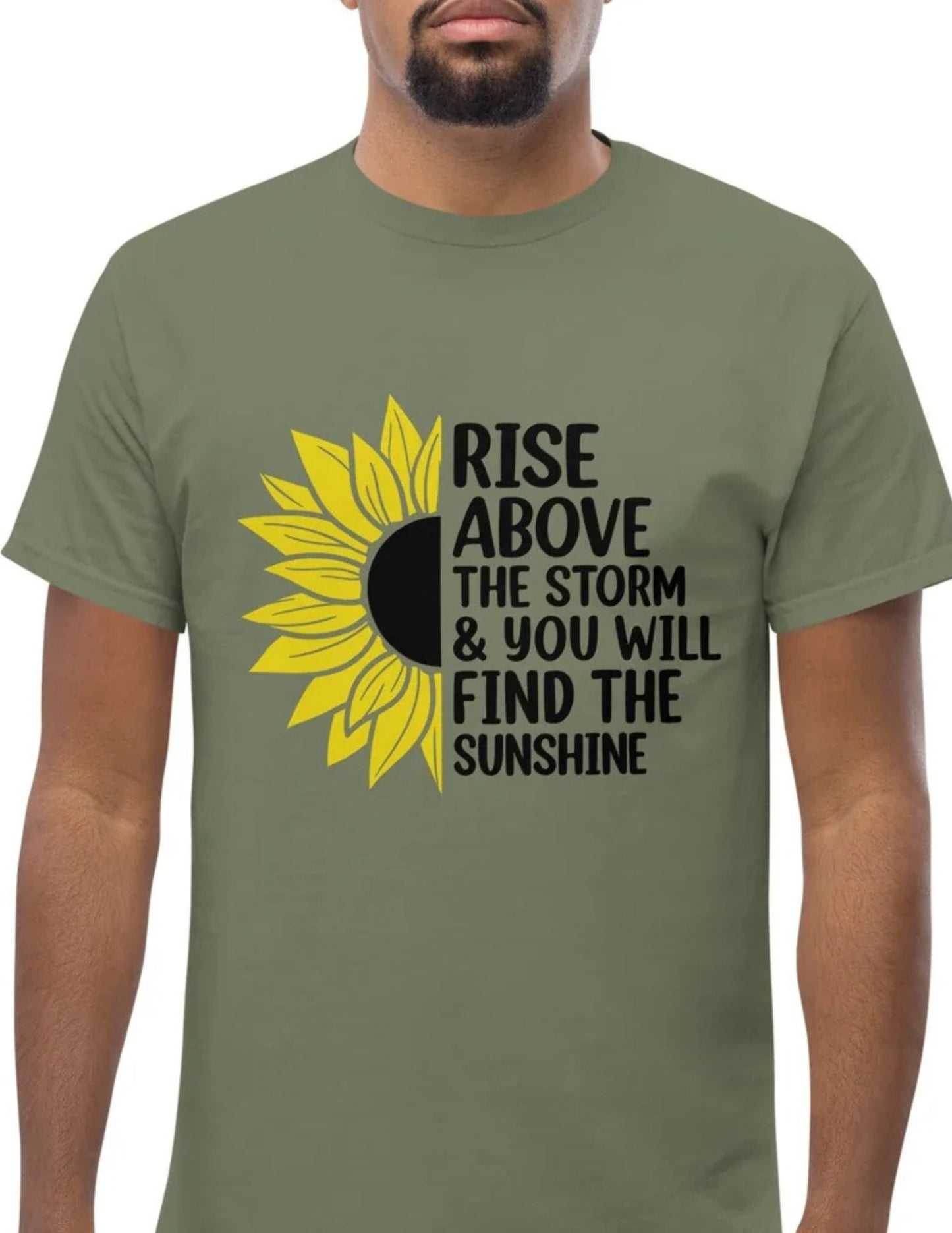 Green t-shirt with a half sunflower and motivational quote “Rise above the storm & you will find the sunshine” in black text.