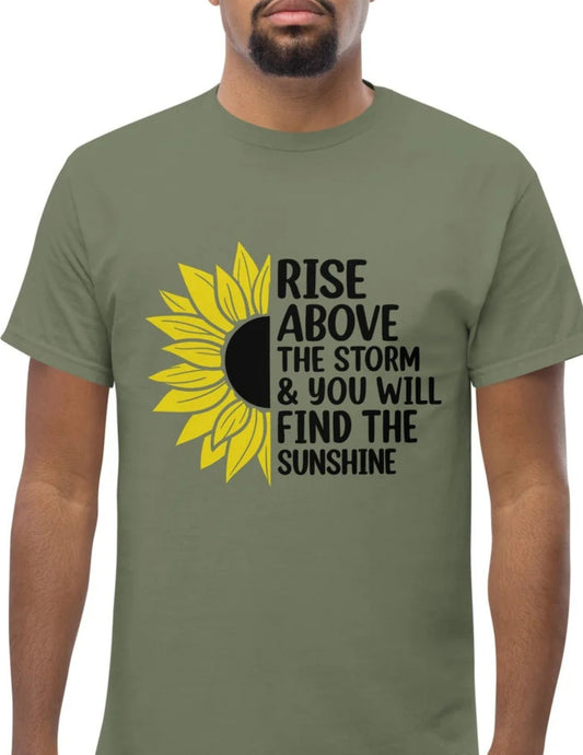 Green t-shirt with a half sunflower and motivational quote “Rise above the storm & you will find the sunshine” in black text.