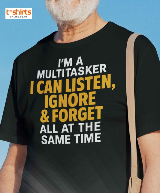 Person wearing a black t-shirt with humorous text design against a clear blue sky.
