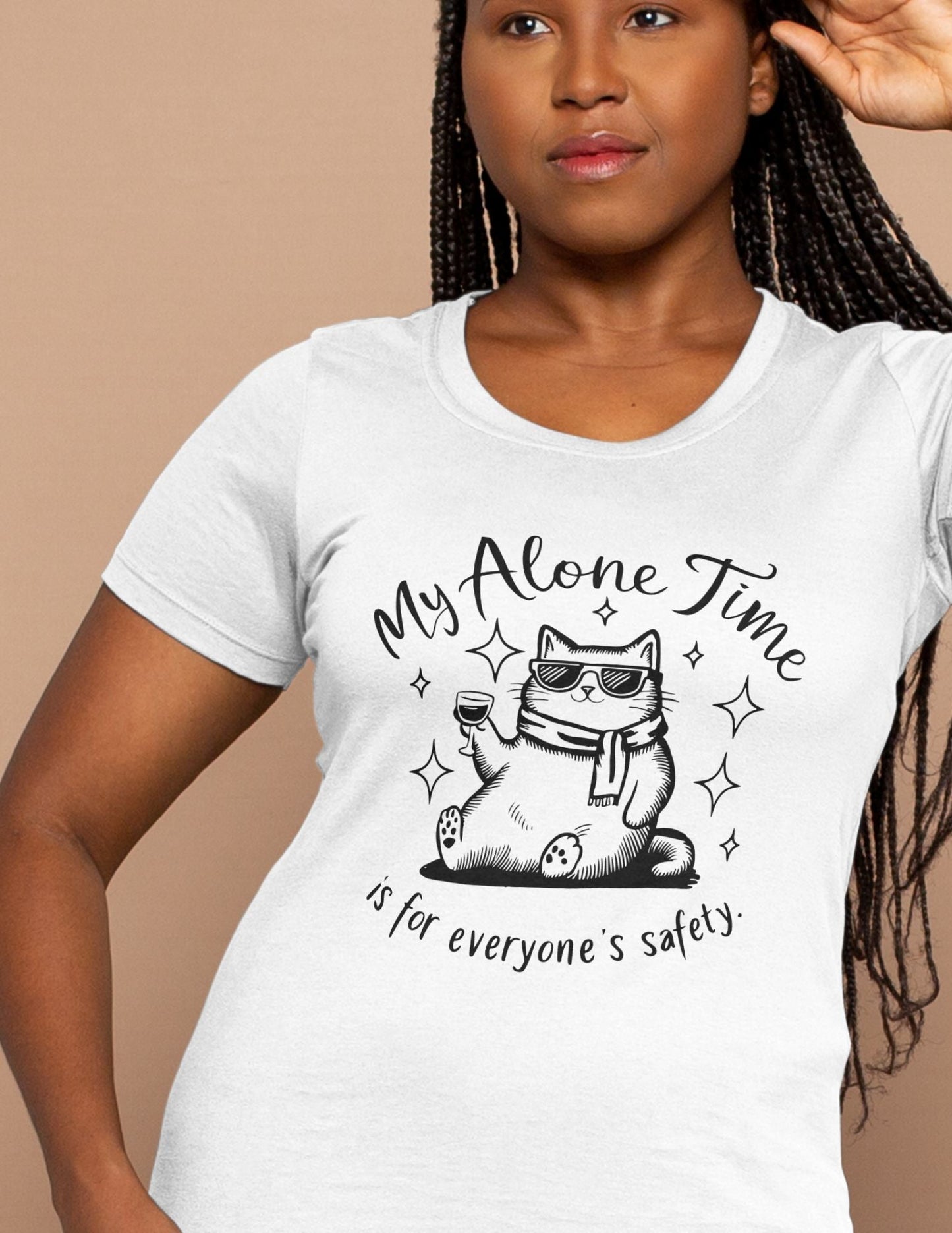 White t-shirt with a cartoon cat in sunglasses holding a glass of wine and quote “My Alone Time is for Everyone’s Safety.”