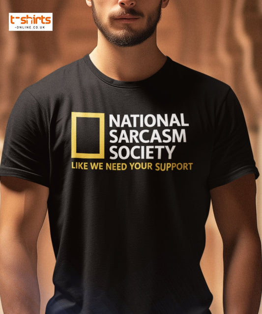 Black t-shirt with 'National Sarcasm Society' text worn by a person, with a brown background.