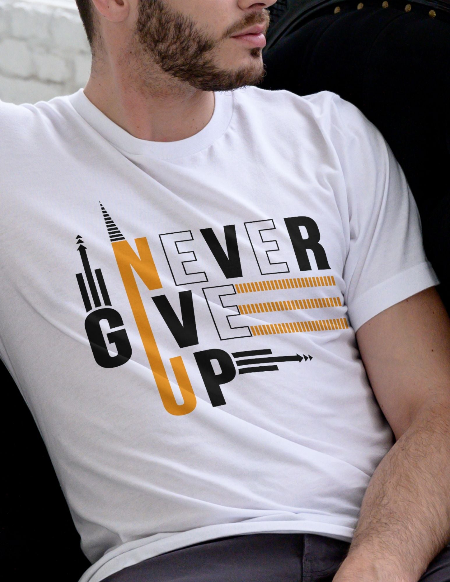 White t-shirt with bold black and gold text that reads “Never Give Up” with arrows and upward motion graphics.