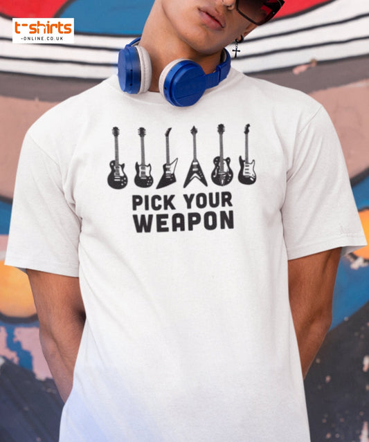Person wearing a white t-shirt with guitar graphic and 'Pick Your Weapon' text, with colorful background.
