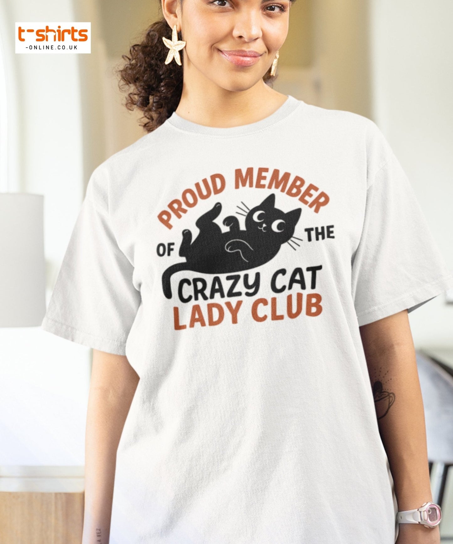 Woman wearing a white t-shirt with a cat-themed design and text.