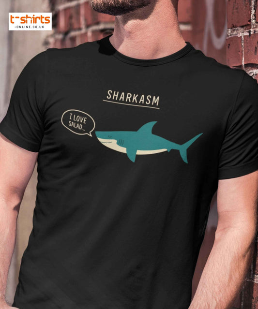 Black t-shirt with shark graphic and 'Sharkasm' text worn by a person.