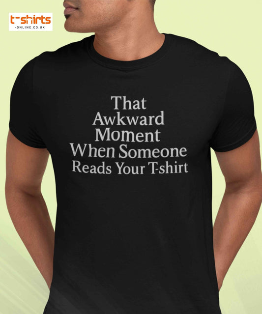Black t-shirt with humorous text worn by a person on a light yellow background
