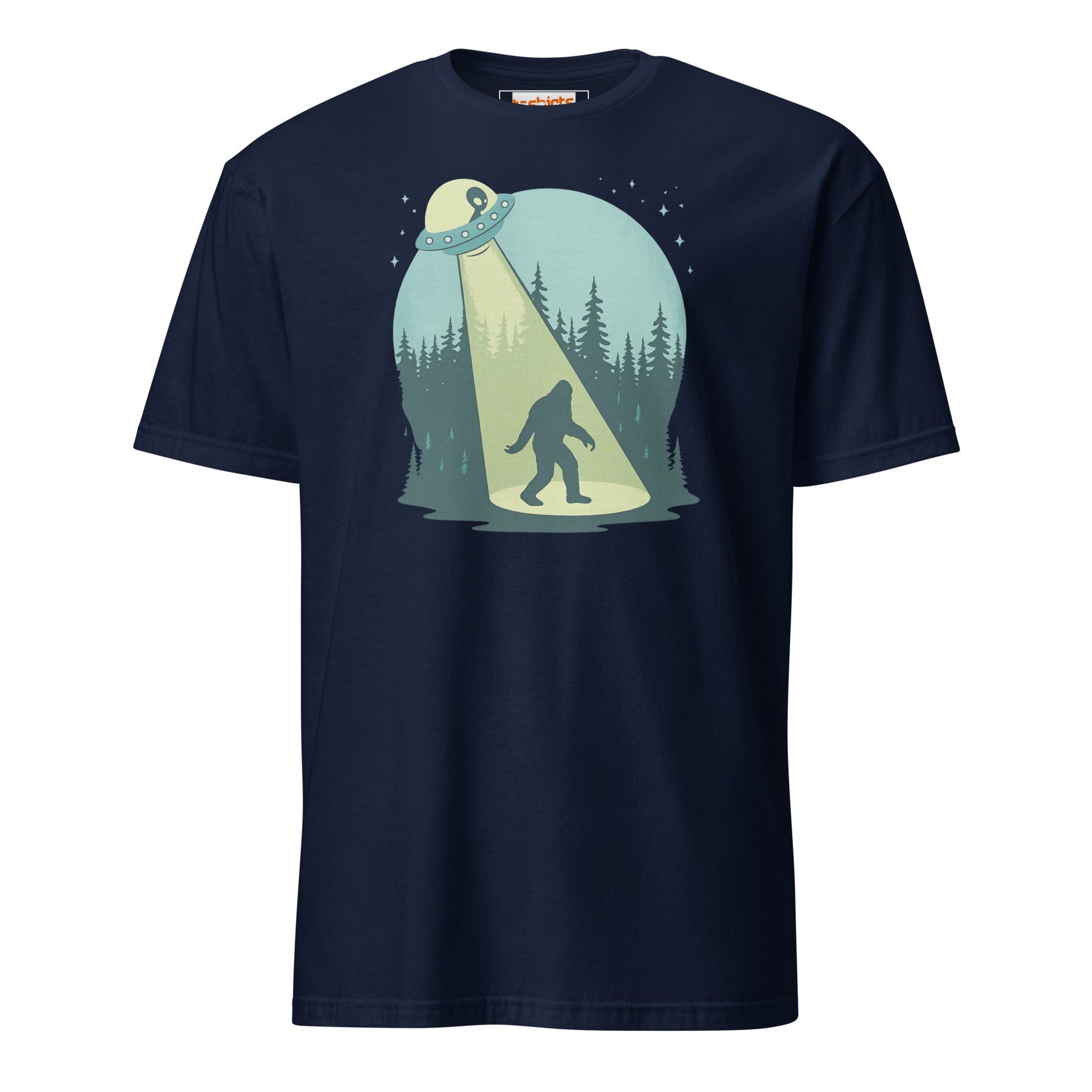 Navy blue t-shirt with a graphic of a person in a spotlight on a bigfoot in a forest.