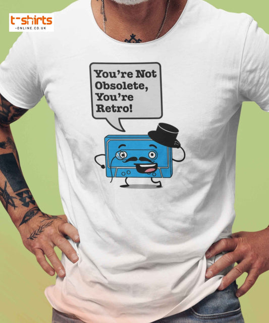 Person wearing a white t-shirt with a blue cassette tape graphic and text 'You're Not Obsolete, You're Retro!' on a green background.