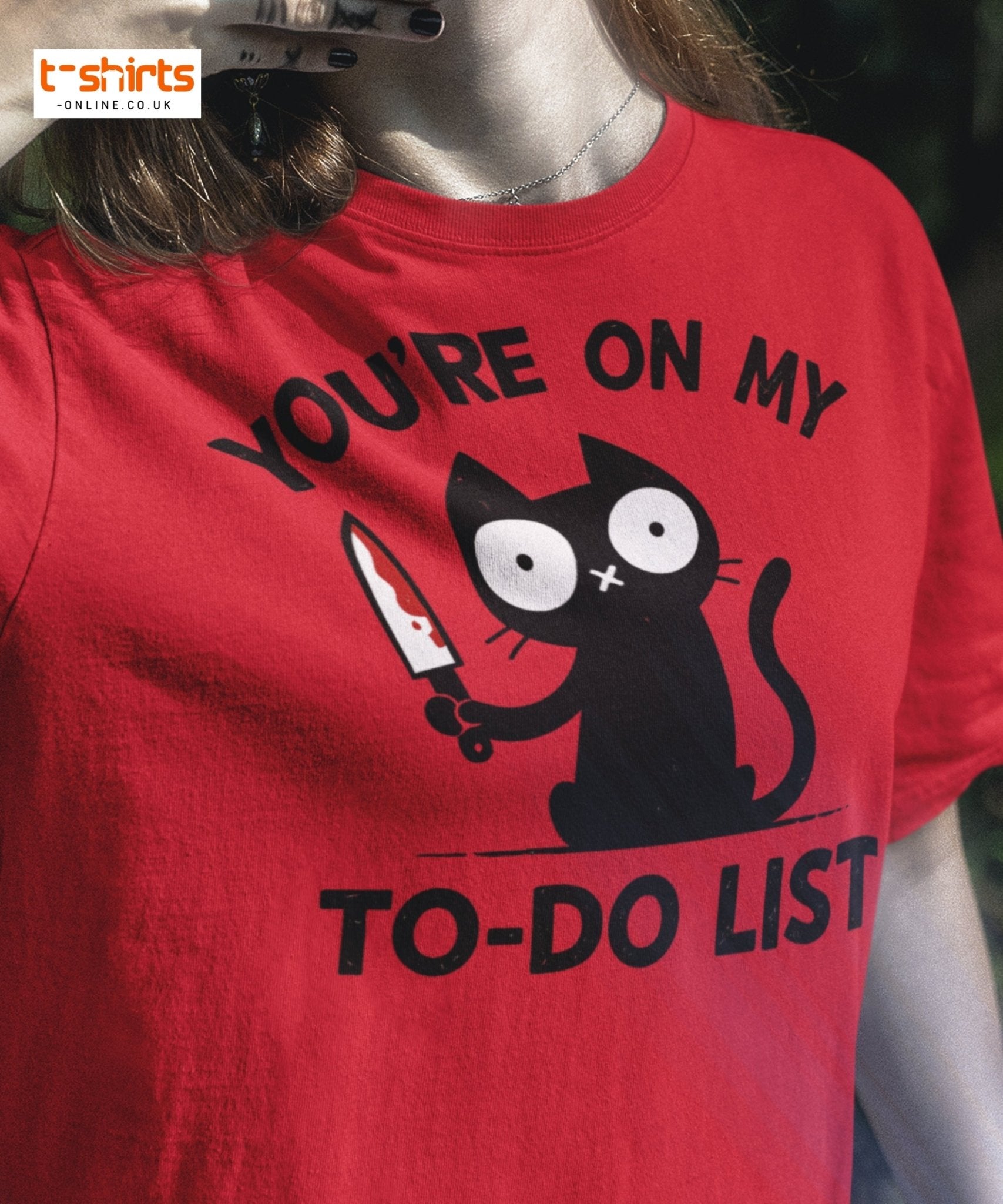 Red t-shirt with a black cat graphic and text 'You're on my to-do list' worn by a person.